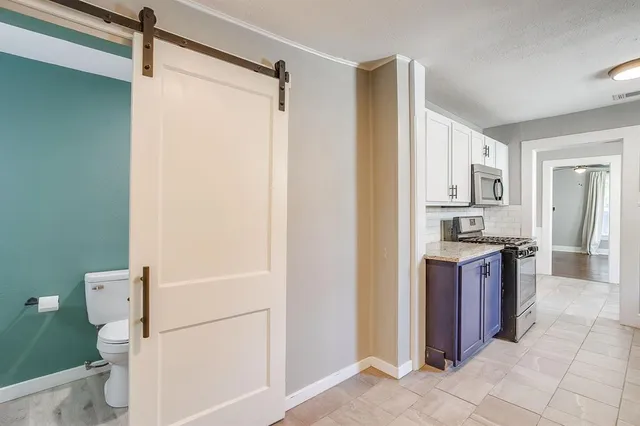 a large bathroom with a granite countertop sink and a mirror