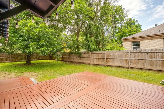 a view of a backyard with swimming pool
