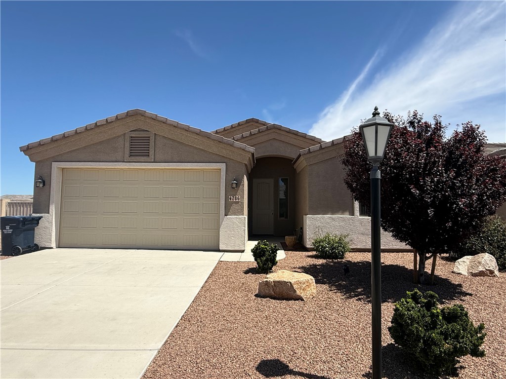 4786 East Old W Road Kingman, AZ 86401 - Photo 1 of 12 Stucco exterior with a tiled roof and an integrated two-car garage
