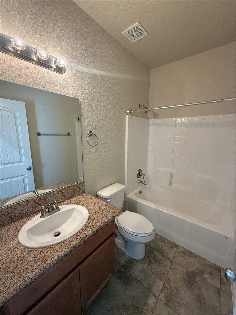 4786 East Old W Road Kingman, AZ 86401 - Photo 4 of 12 Bathroom featuring a shower-tub combination, ceramic tile flooring, a single vanity with a laminate countertop, and a built-in exhaust fan