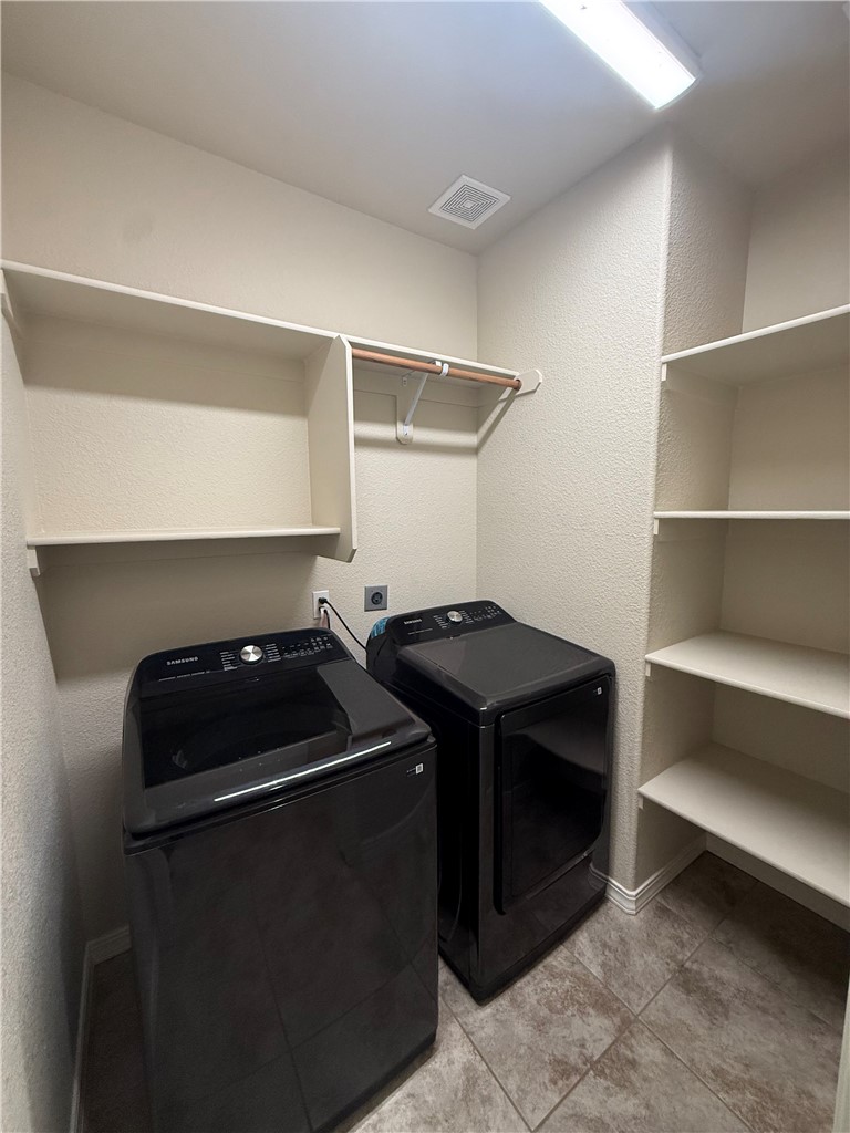 4786 East Old W Road Kingman, AZ 86401 - Photo 7 of 12 Dedicated utility room featuring tiled flooring, built-in shelving, a clothes hanging rod, and ceiling-mounted lighting
