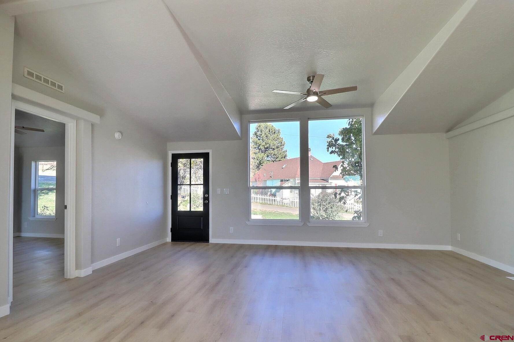 761 Stahl Road Paonia, CO 81428 - Photo 11 of 39 an empty room with wooden floor and windows