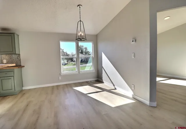 a view of a room with wooden floor and a window