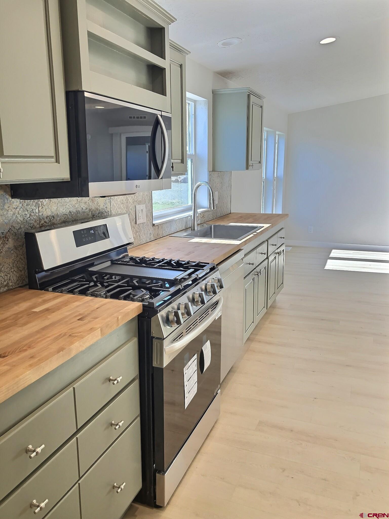 761 Stahl Road Paonia, CO 81428 - Photo 15 of 39 a kitchen with stainless steel appliances granite countertop a stove and a microwave