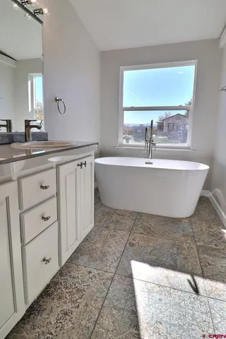 a bathroom with a bathtub and a sink