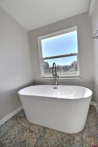 a white bath tub sitting in a bathroom