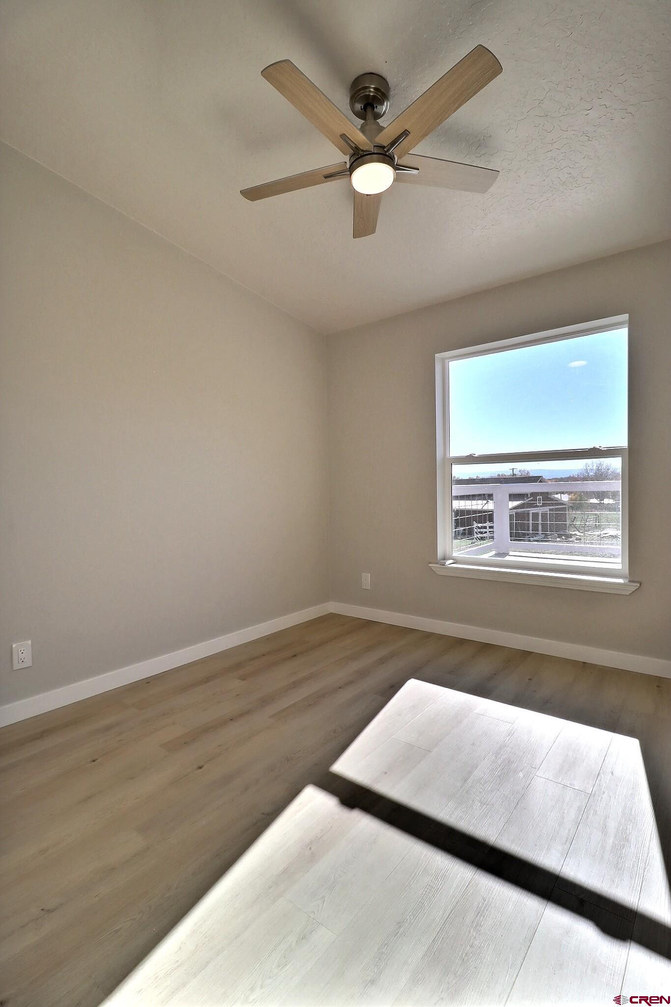 761 Stahl Road Paonia, CO 81428 - Photo 28 of 39 an empty room with wooden floor and windows
