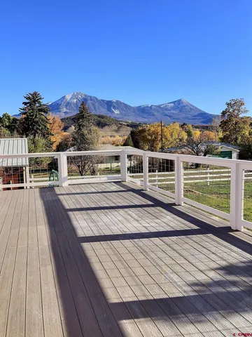 a view of a balcony with wooden floor and city view