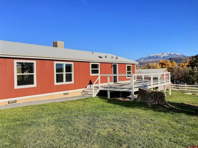 a front view of a house with a garden and porch