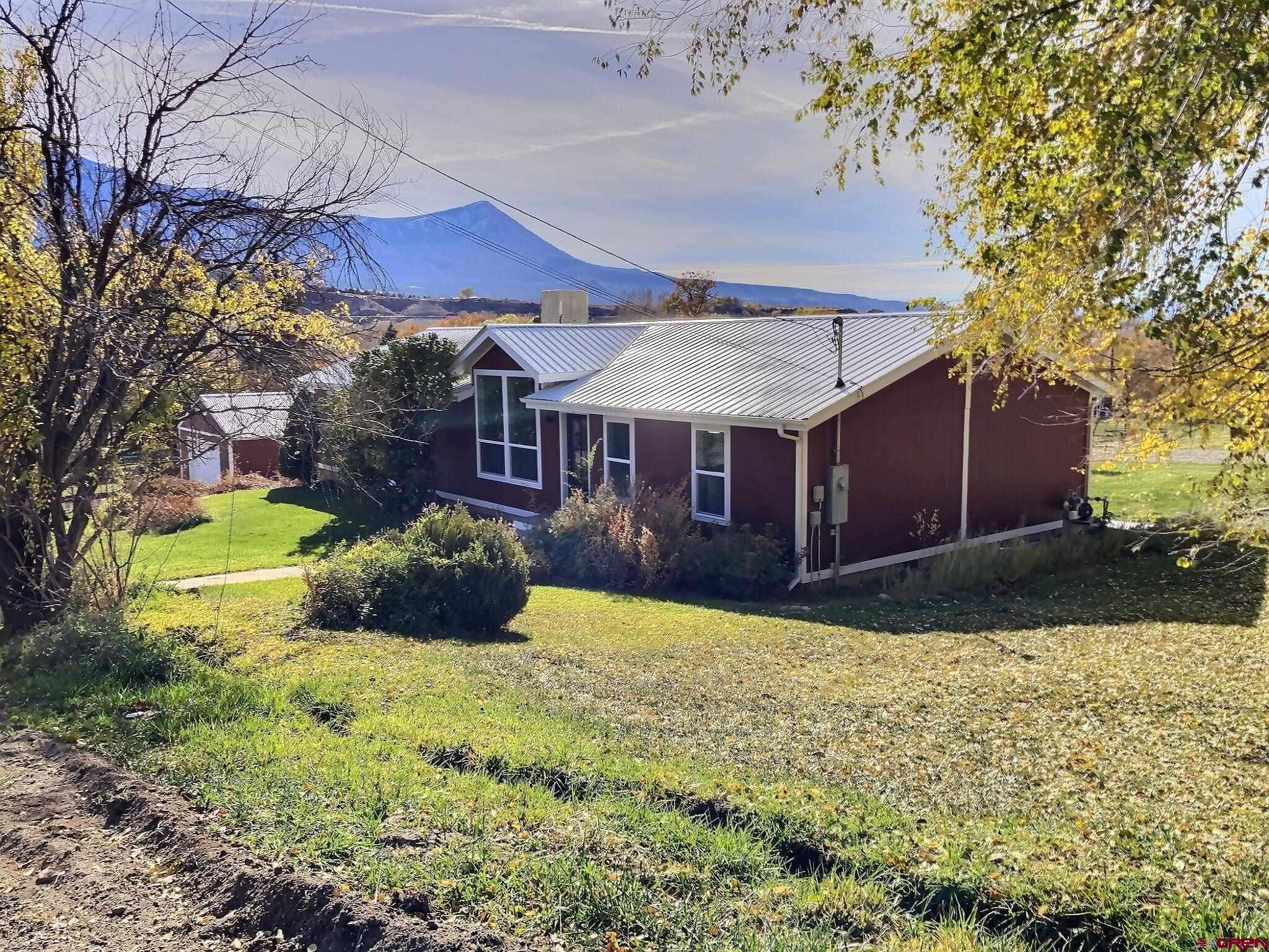 761 Stahl Road Paonia, CO 81428 - Photo 5 of 39 a view of a house with a yard and a garden