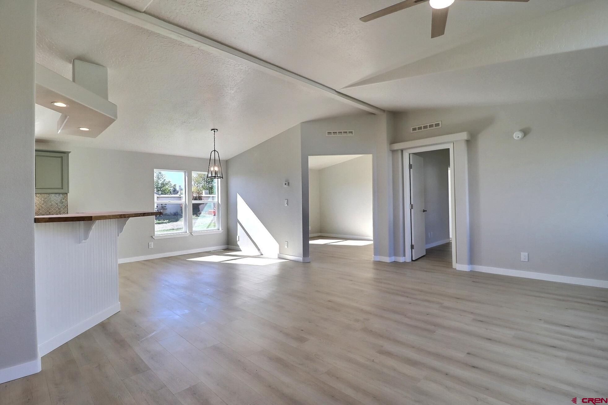 761 Stahl Road Paonia, CO 81428 - Photo 9 of 39 a view of an empty room with wooden floor kitchen view