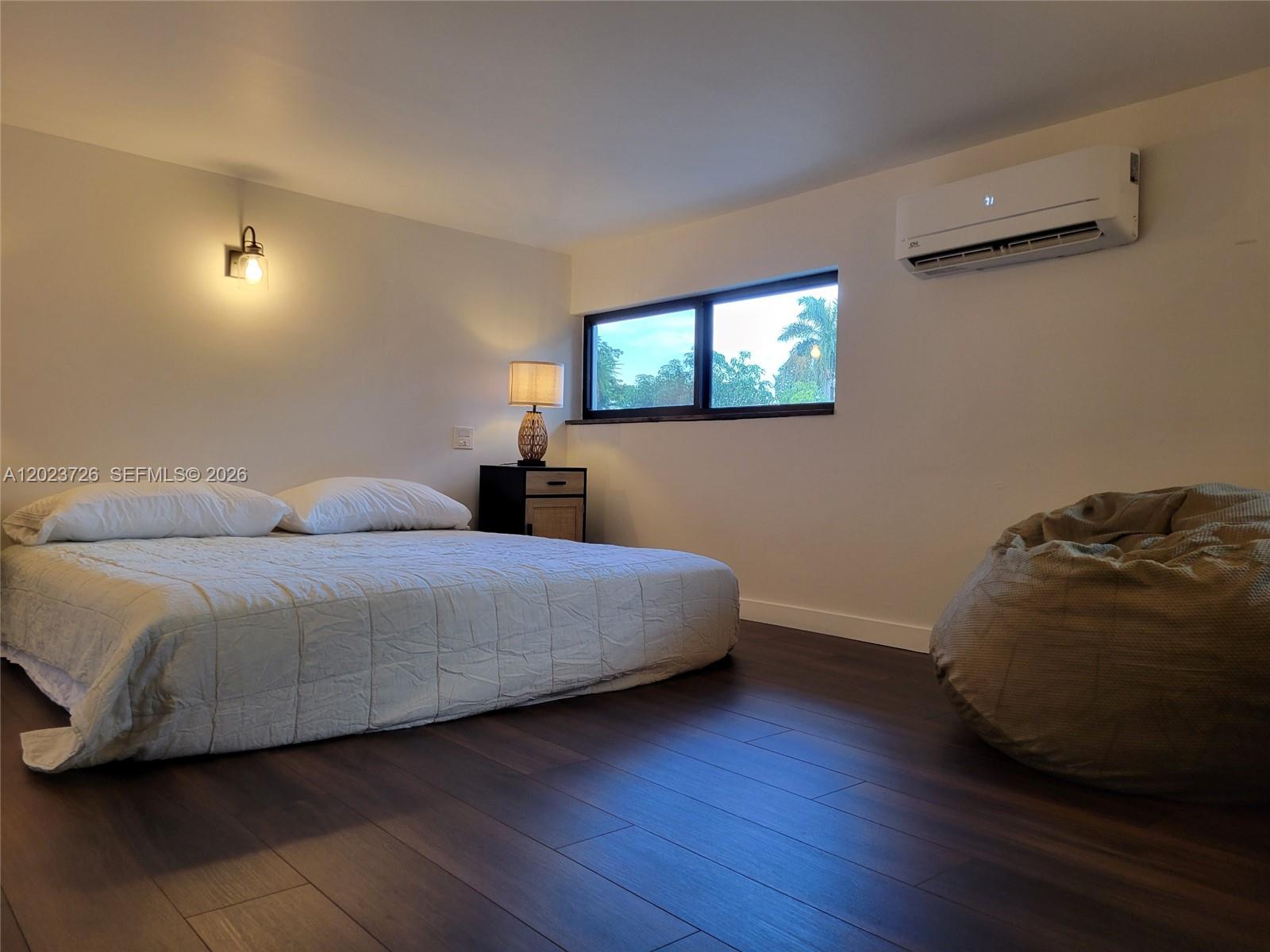 5866 Southwest 60th Street, Unit 3 Miami, FL 33143 - Photo 1 of 8 a bedroom with a bed and a night stand