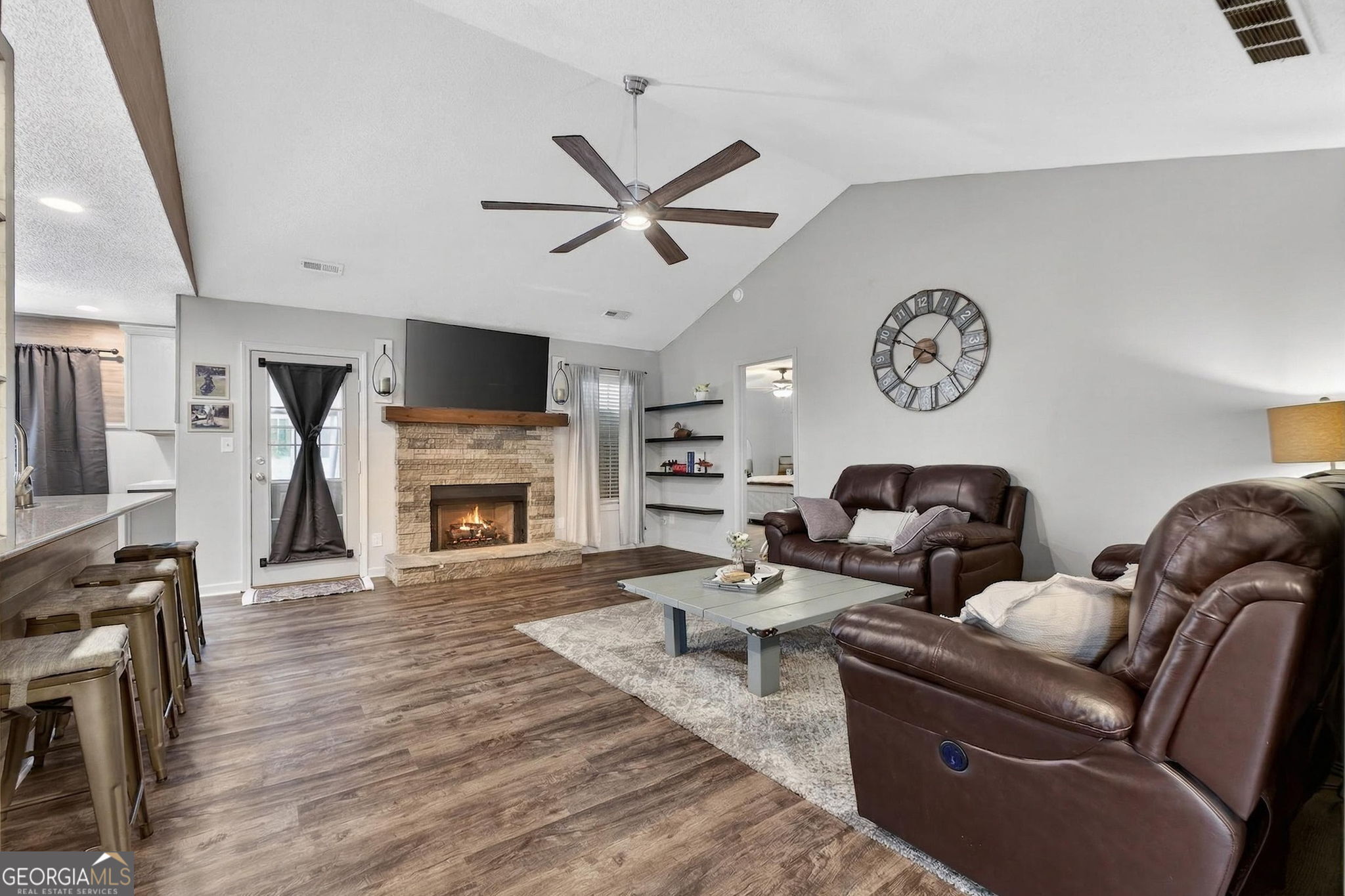 417 Stuarts Lane Locust Grove, GA 30248 - Photo 13 of 48 a living room with furniture a flat screen tv and a fireplace