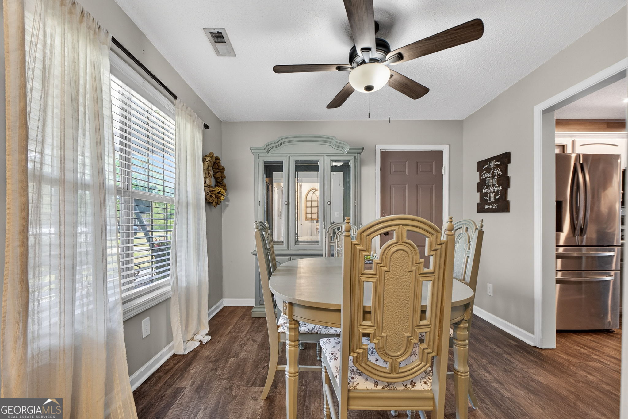 417 Stuarts Lane Locust Grove, GA 30248 - Photo 16 of 48 a view of a dining room with furniture window and wooden floor