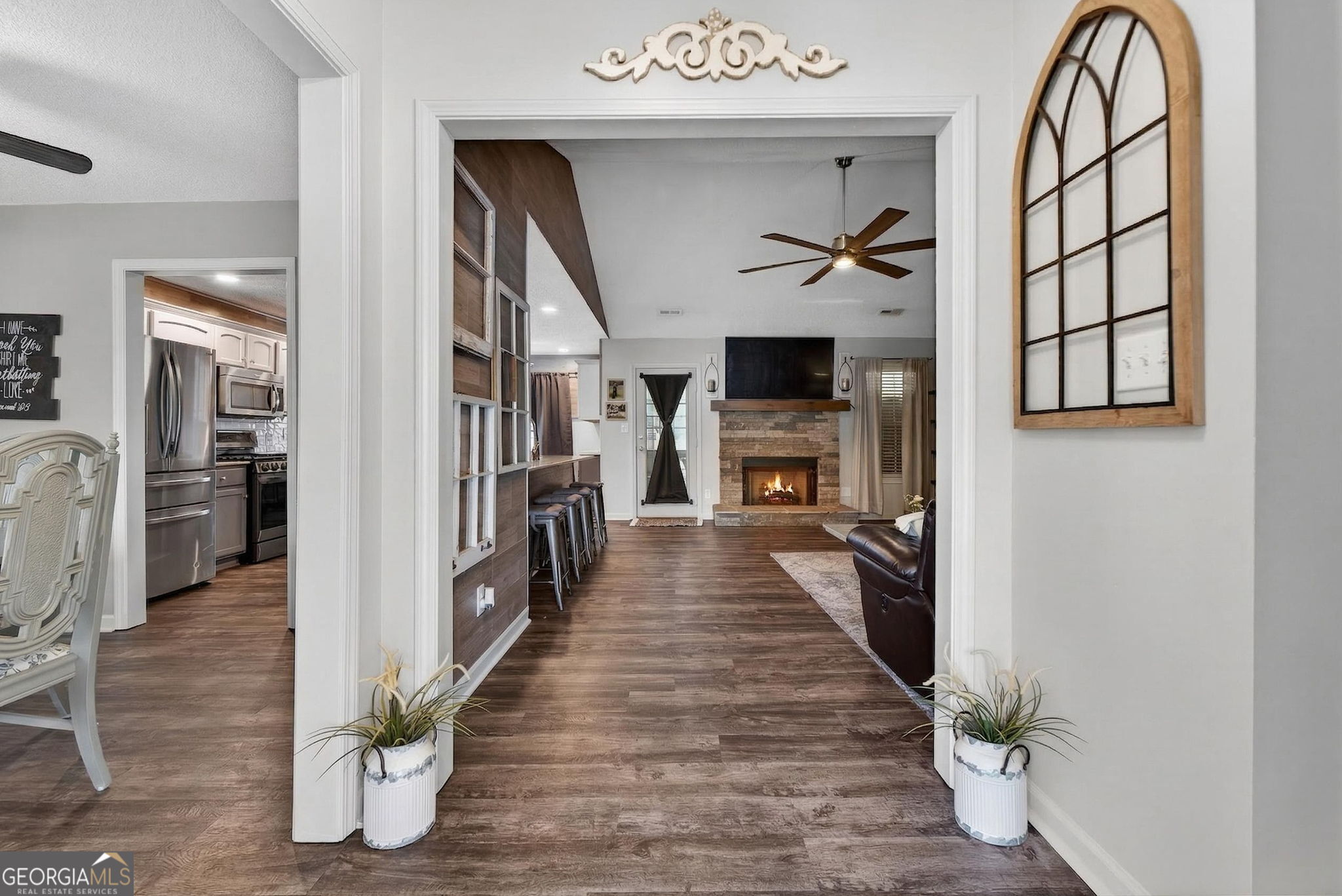 417 Stuarts Lane Locust Grove, GA 30248 - Photo 17 of 48 a view of a hallway with wooden floor and a fireplace