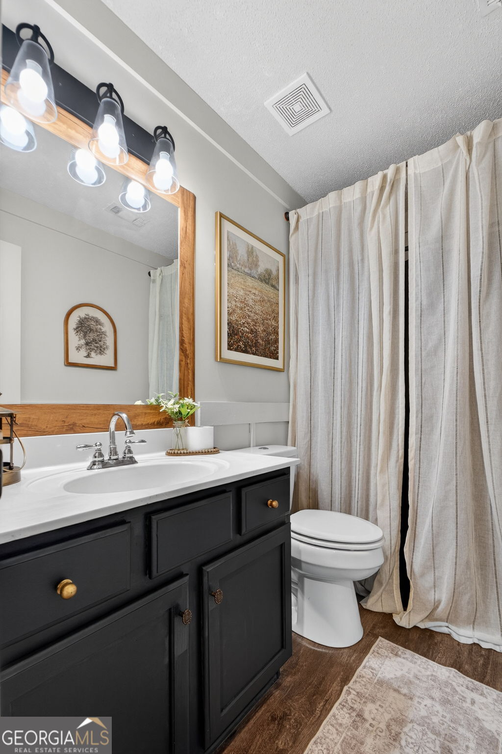 417 Stuarts Lane Locust Grove, GA 30248 - Photo 27 of 48 a bathroom with a double vanity sink toilet and a mirror