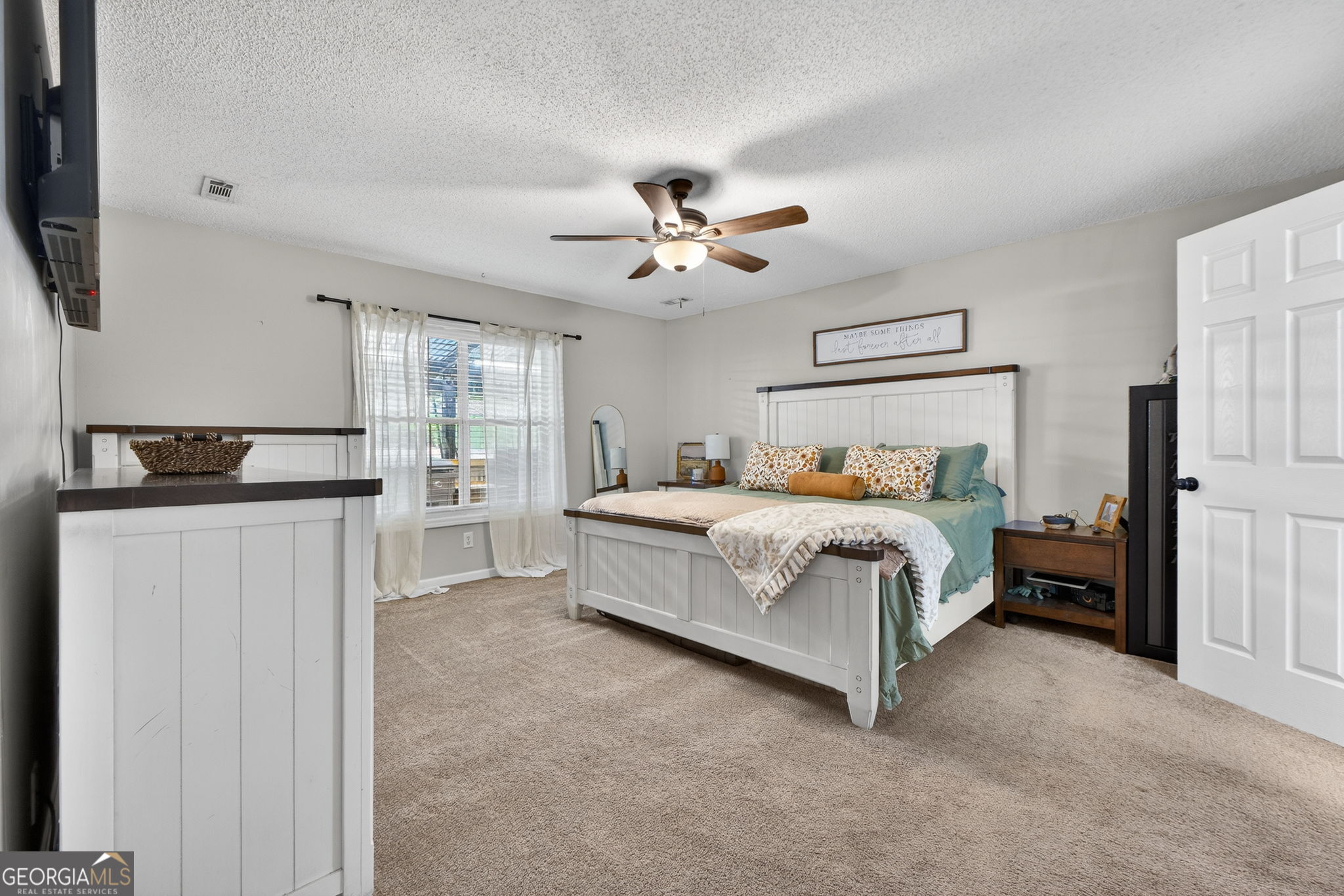 417 Stuarts Lane Locust Grove, GA 30248 - Photo 3 of 48 a bedroom with bed and a chandelier