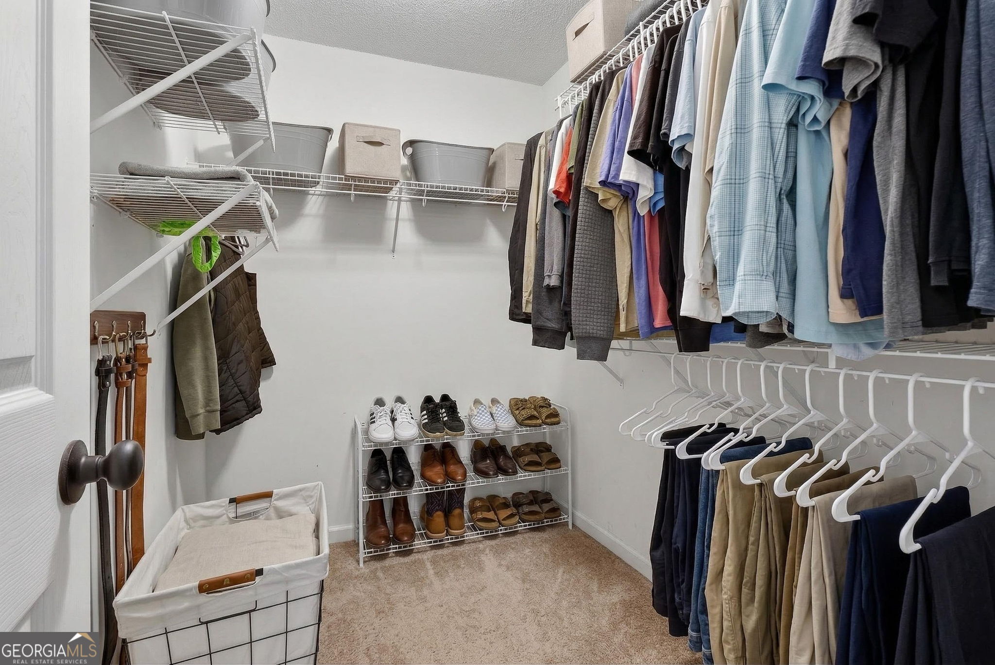 417 Stuarts Lane Locust Grove, GA 30248 - Photo 33 of 48 a view of walk in closet with clothes and shoes