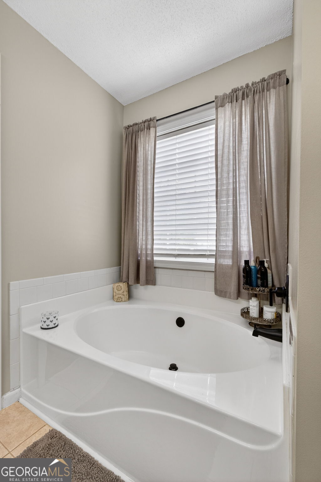 417 Stuarts Lane Locust Grove, GA 30248 - Photo 37 of 48 a bath tub sitting in a bathroom next to a window
