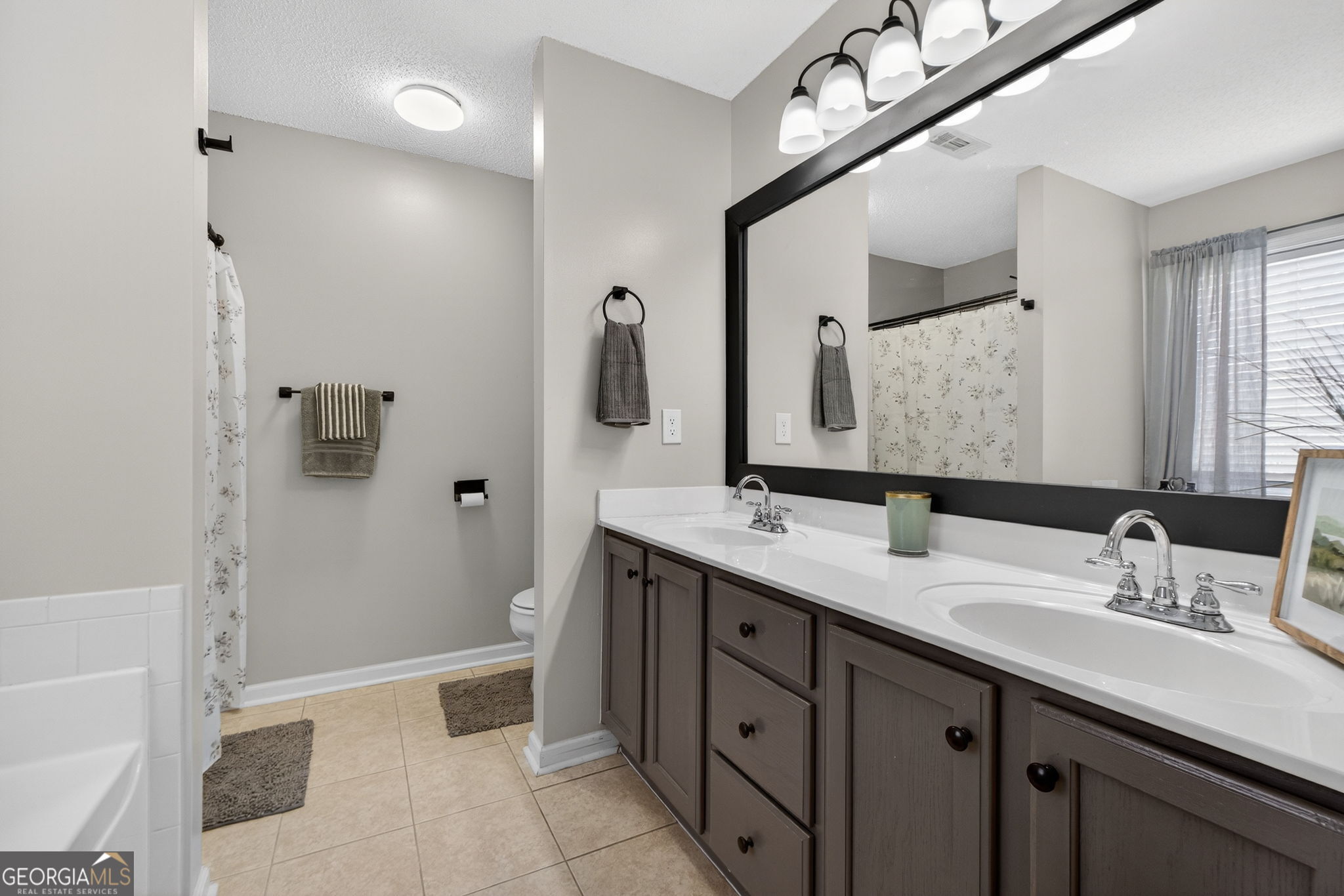 417 Stuarts Lane Locust Grove, GA 30248 - Photo 38 of 48 a bathroom with a double vanity sink mirror and shower