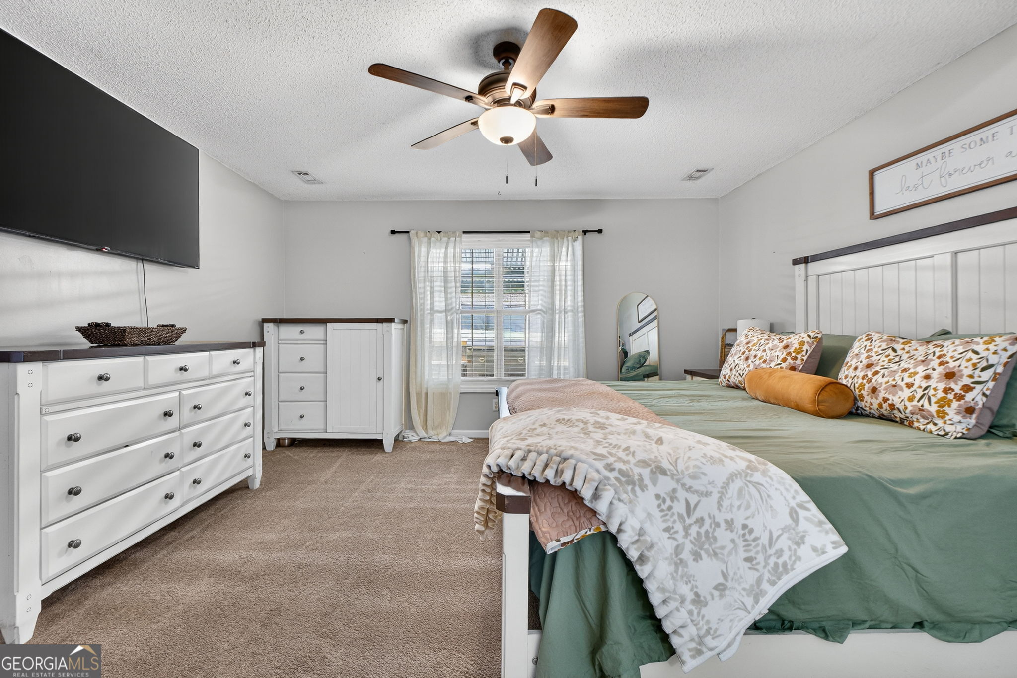 417 Stuarts Lane Locust Grove, GA 30248 - Photo 40 of 48 a bedroom with a bed and flat screen tv