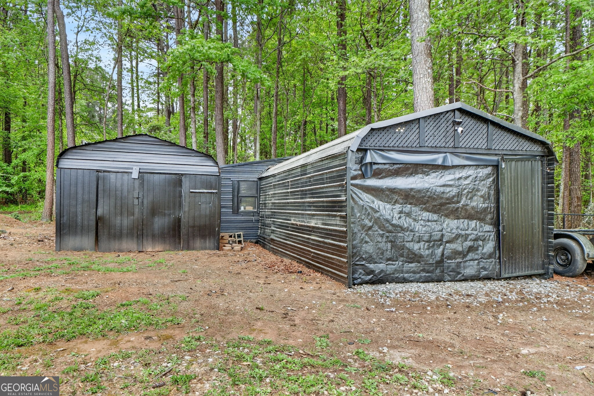 417 Stuarts Lane Locust Grove, GA 30248 - Photo 48 of 48 a backyard of a house with large trees and a wooden fence