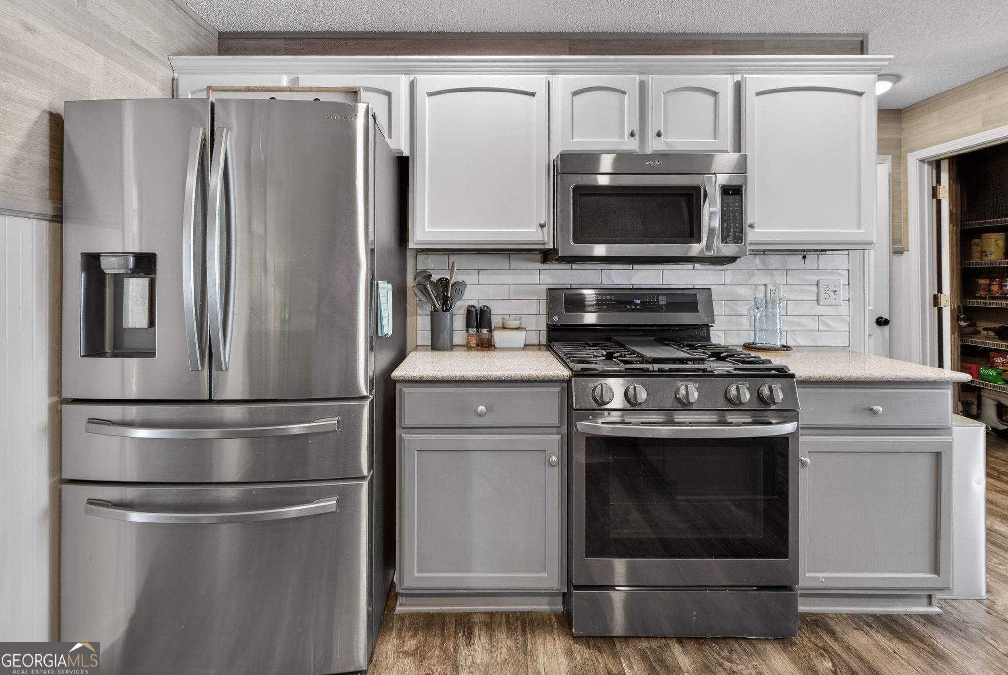 417 Stuarts Lane Locust Grove, GA 30248 - Photo 9 of 48 a kitchen with stainless steel appliances a refrigerator stove and microwave