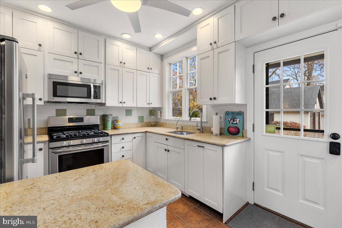 29 Jefferson Road Princeton, NJ 08540 - Photo 12 of 24 a kitchen with white cabinets and appliances