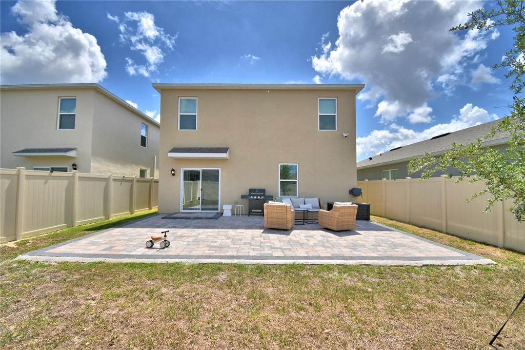 2839 Moulin Road Davenport, FL 33837 - Photo 61 of 75 a view of a house with backyard and sitting area