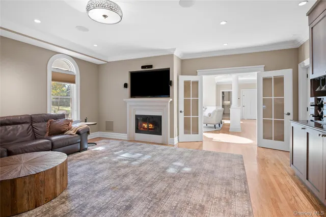 a living room with furniture a fireplace and a flat screen tv