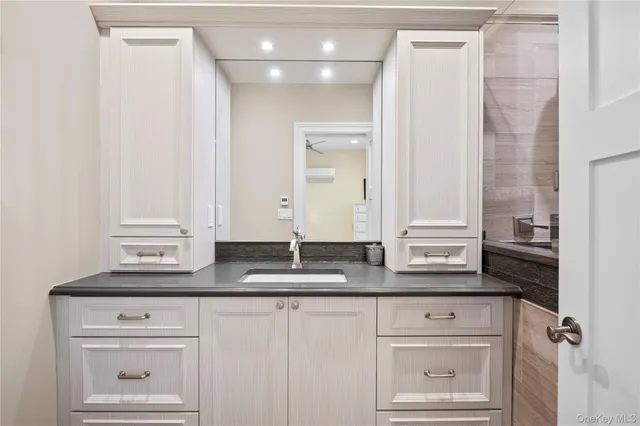 a bathroom with a sink and a mirror