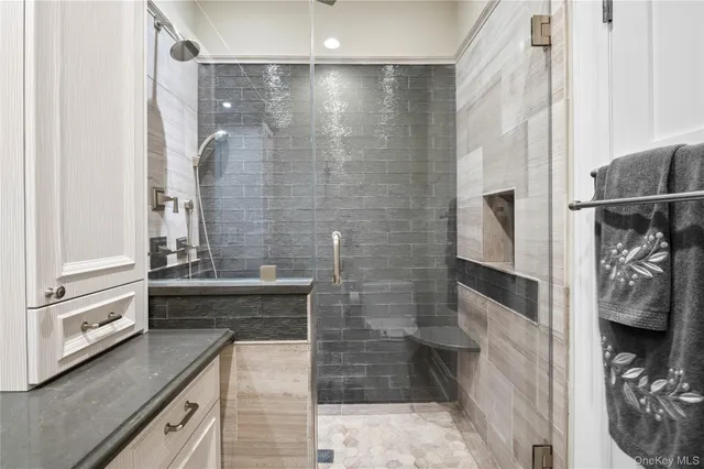 a bathroom with a granite countertop bathtub shower and sink