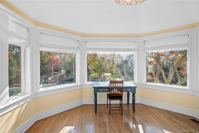 a view of a room with wooden floor and a window