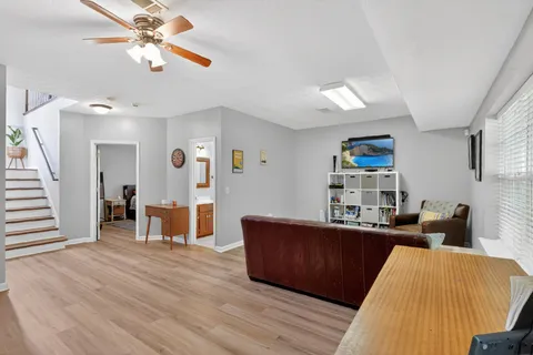 a living room with furniture and a wooden floor