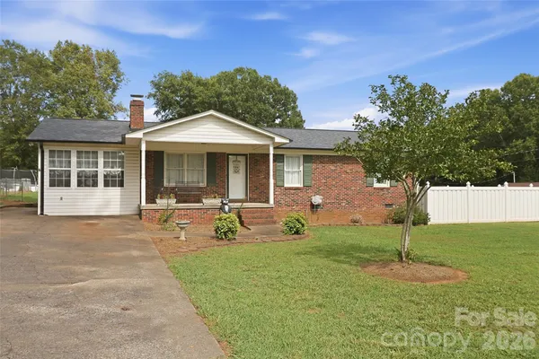 a front view of a house with garden and porch