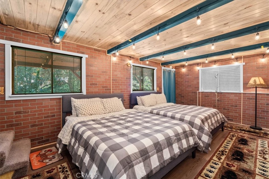 697 Mormon Springs Road Crestline, CA 92325 - Photo 15 of 37 a bed sitting in a bedroom next to a balcony