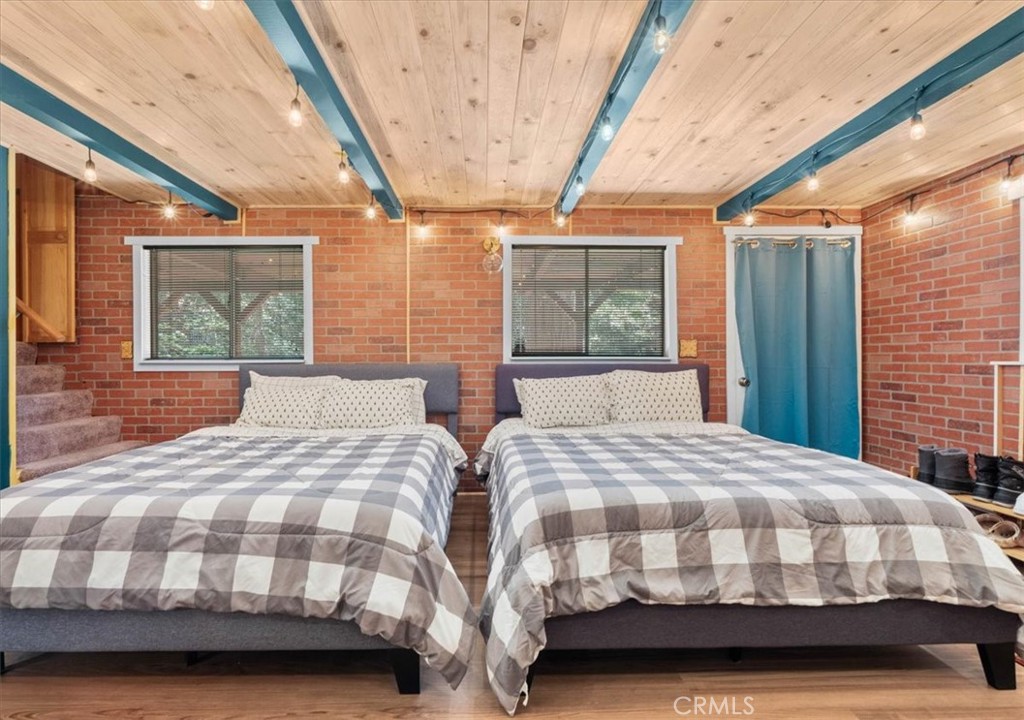 697 Mormon Springs Road Crestline, CA 92325 - Photo 16 of 37 a bedroom with two beds and a large window