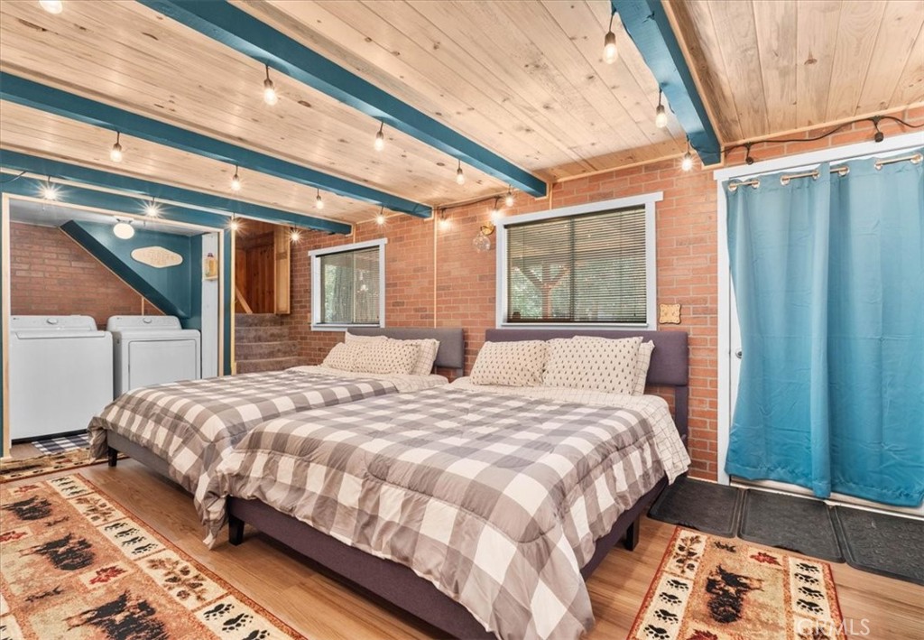 697 Mormon Springs Road Crestline, CA 92325 - Photo 17 of 37 a bedroom with a large bed and a large window