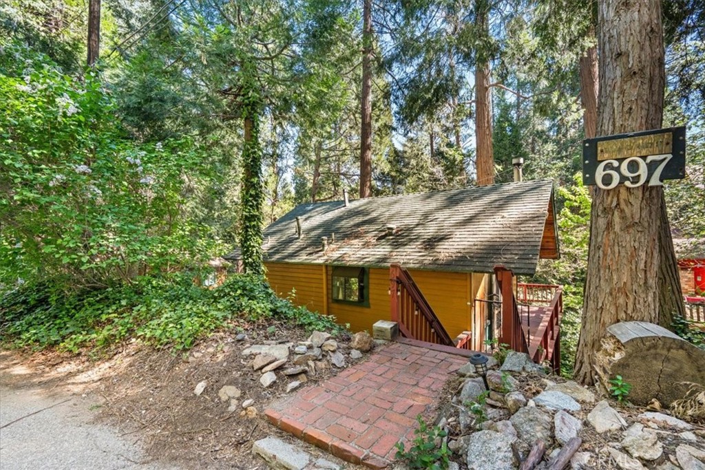 697 Mormon Springs Road Crestline, CA 92325 - Photo 2 of 37 a view of a house with a tree next to a yard