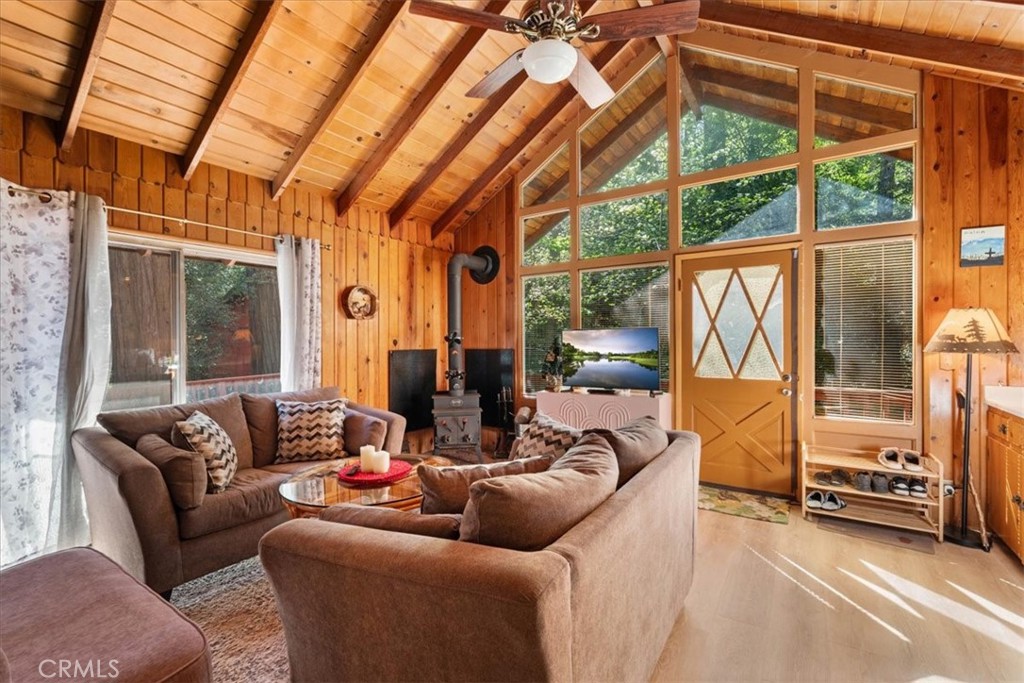 697 Mormon Springs Road Crestline, CA 92325 - Photo 5 of 37 a living room with furniture and a floor to ceiling window