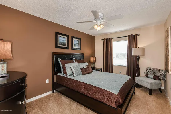 a spacious bedroom with a bed and window