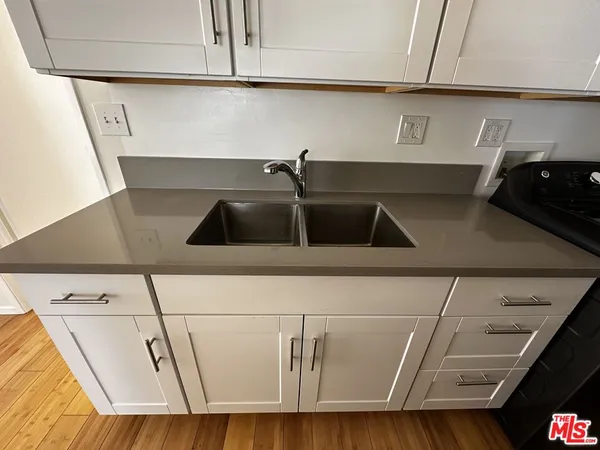 a kitchen with a sink and cabinets