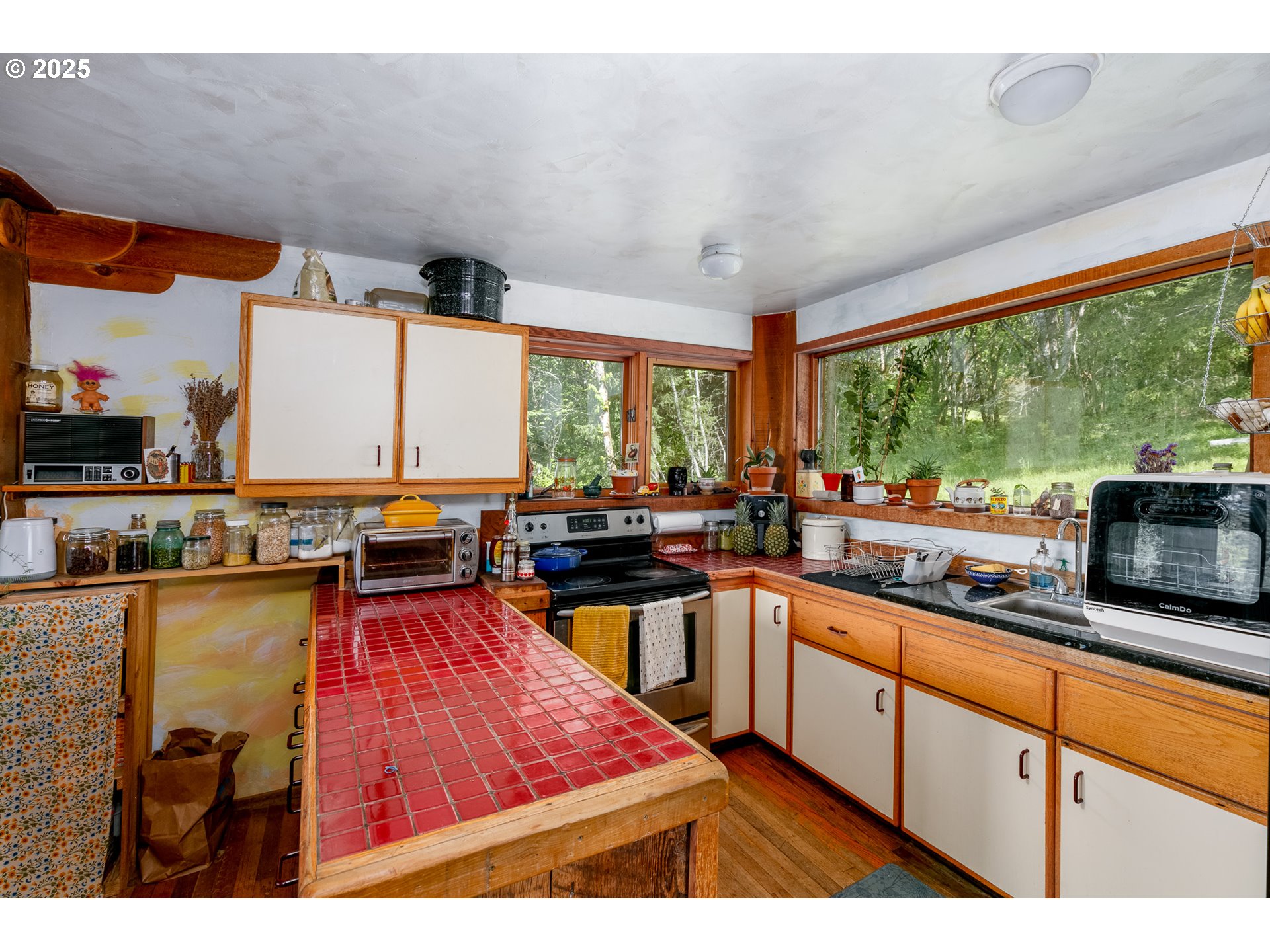 13 Southwest Arnett Road White Salmon, WA 98672 - Photo 12 of 25 a kitchen with lots of counter top space and wooden floor