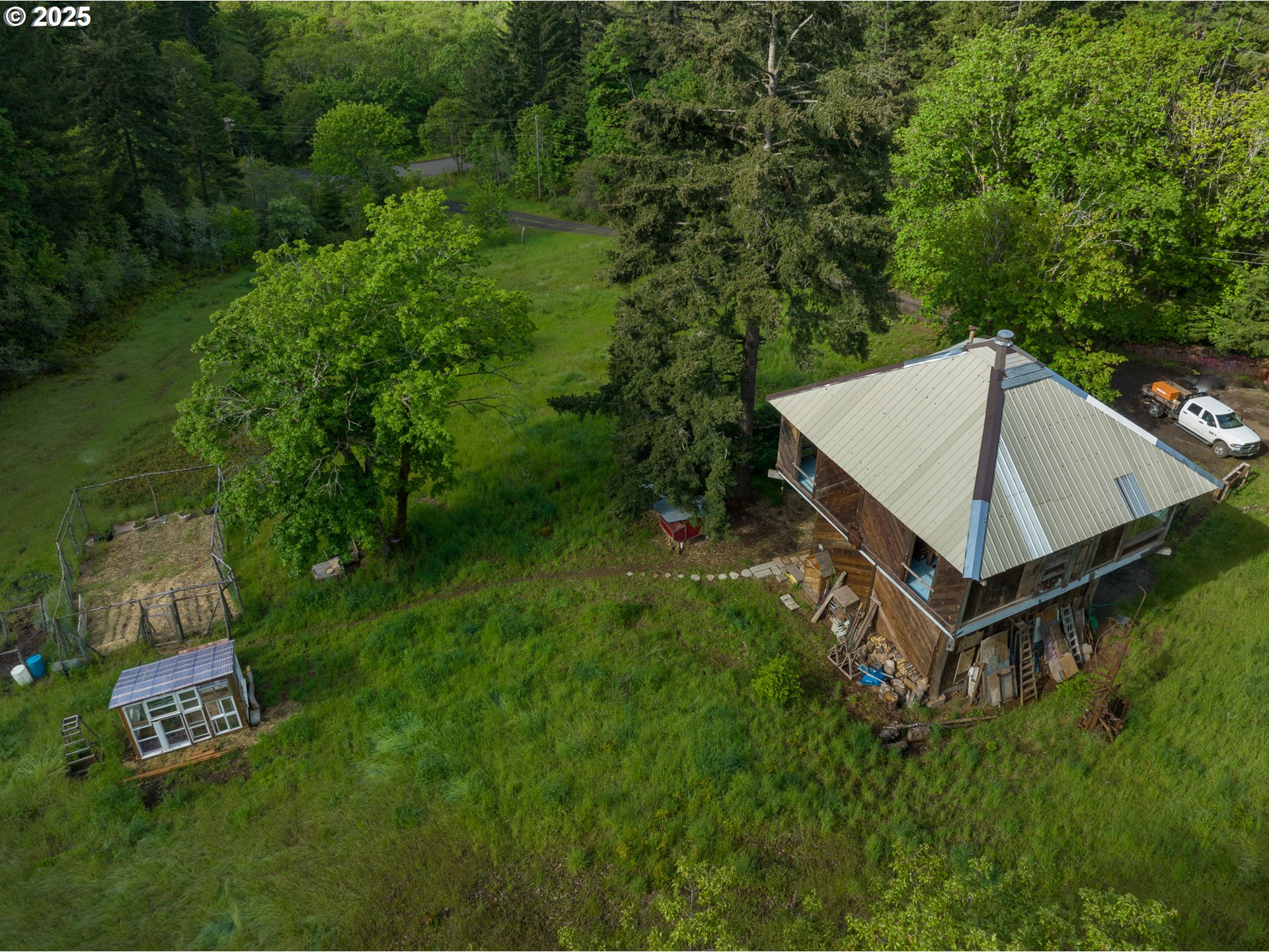 13 Southwest Arnett Road White Salmon, WA 98672 - Photo 20 of 25 a view of a house with a backyard and a patio