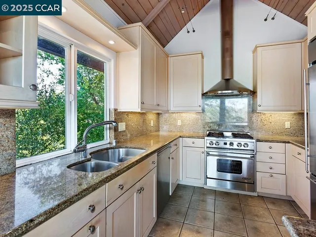 a kitchen with a sink stove and cabinets