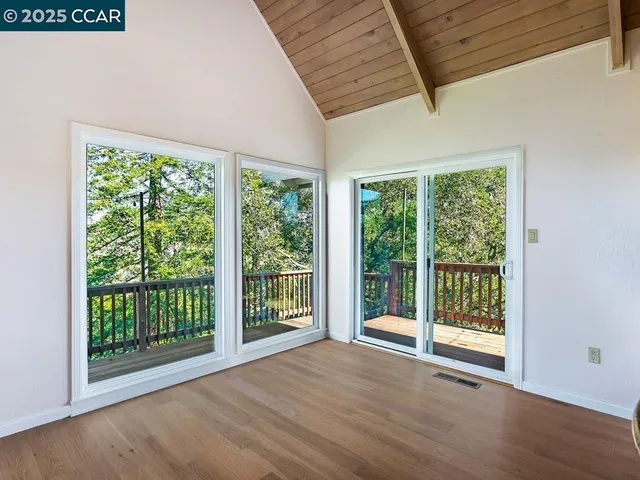 a view of a room with wooden floor and balcony