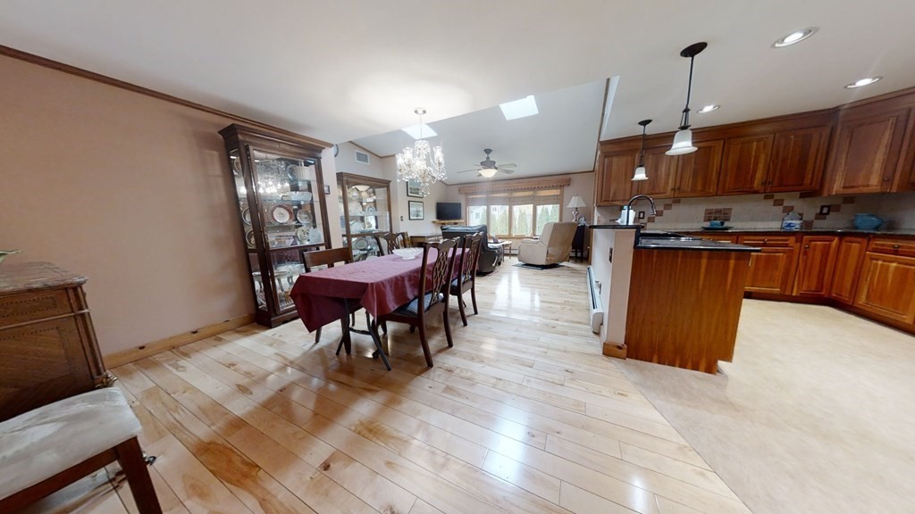 51 Miriam Road Waltham, MA 02451 - Photo 6 of 17 a large kitchen with a table and stainless steel appliances
