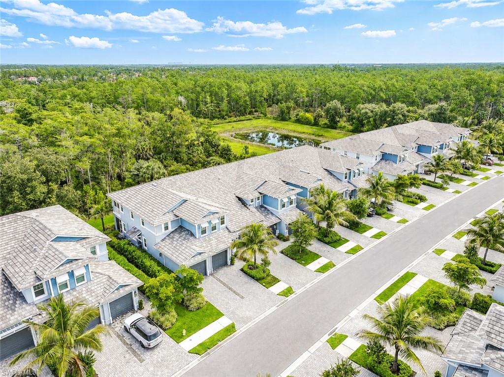 2620 Seychelles Circle, Unit 1302 Naples, FL 34112 - Photo 31 of 43 an aerial view of a house with a garden