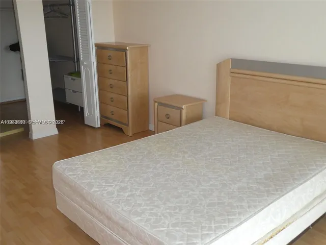 a bedroom with a bed and cabinets