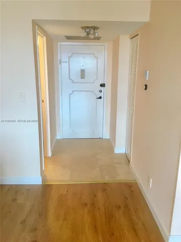 a living room with hard wood floors and a window